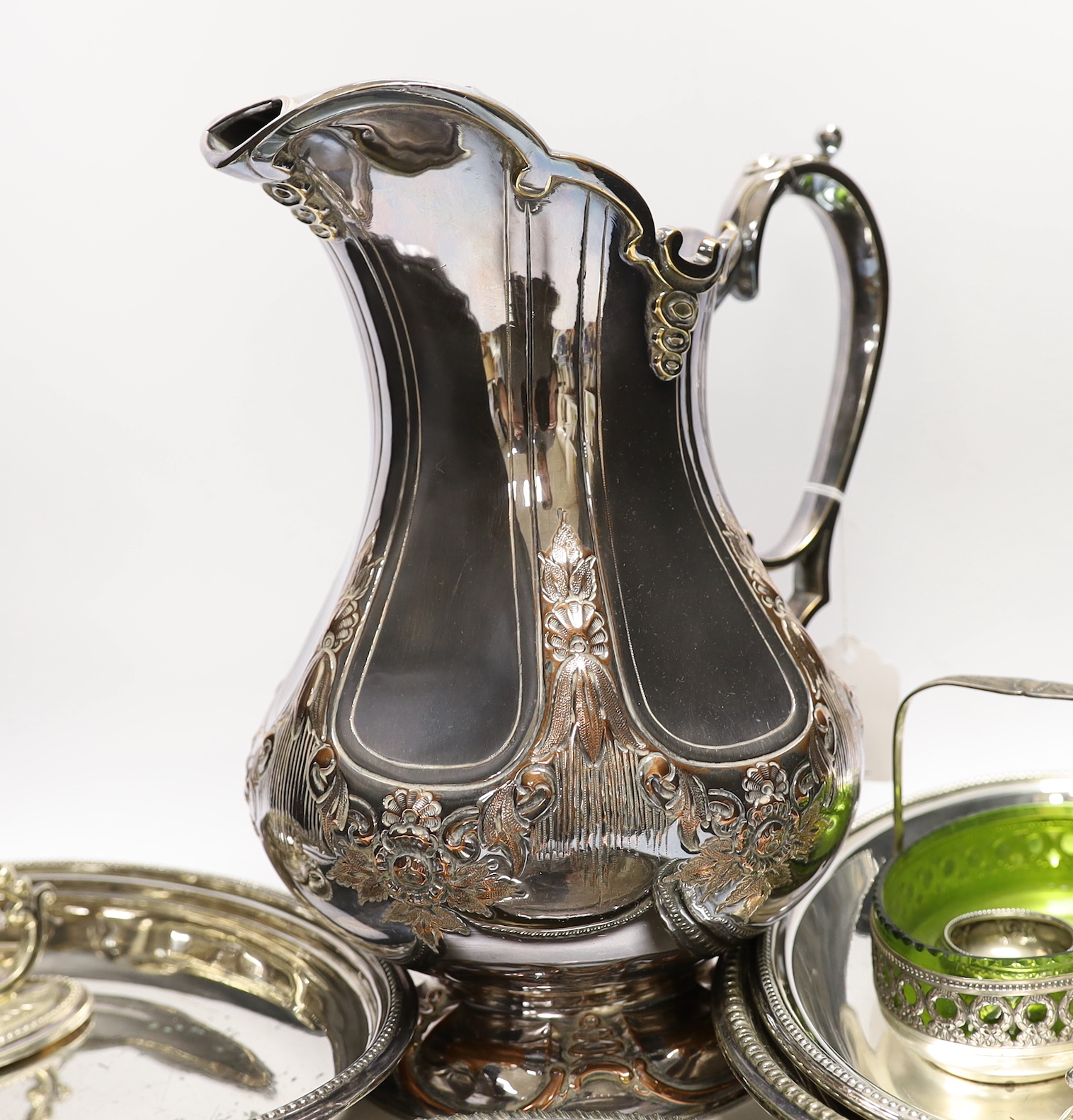 A small silver mustard pot and assorted plated wares including a large copper on electroplate jug, jug 30cm